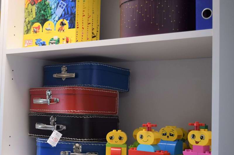 reol med legofigurer og små kufferter